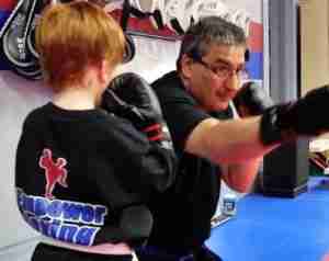 empower kickboxing instructor teacing hook punch