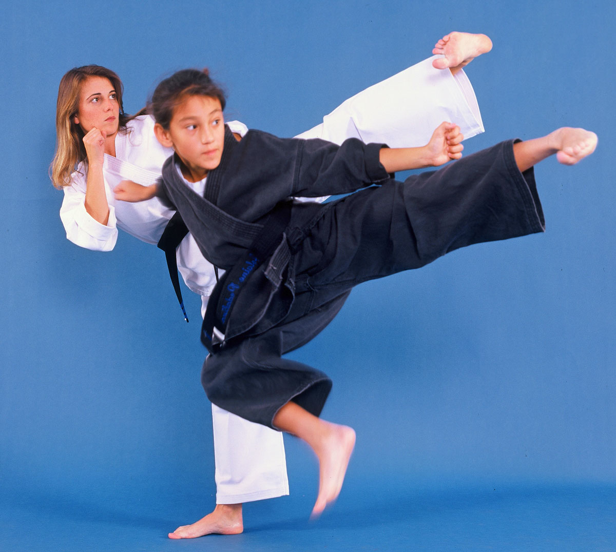 student and instructor side kicking together